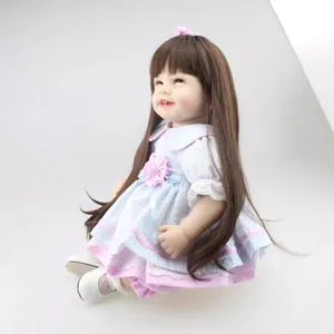 Realistic reborn girl doll with long brown hair in a pink and blue plaid lace dress