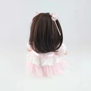 20 inch lifelike girl doll shown from behind with brown hair and pink lace princess dress