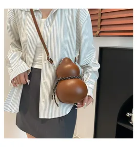 Close-up of brown gourd-shaped crossbody bag with braided rope detail and slim strap