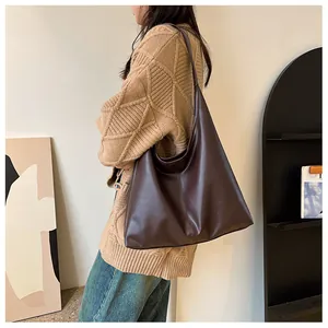 Fashionable dark coffee large capacity tote bag shown as a shoulder bag on a model