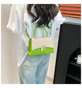 Close-up of retro color-block handbag with woven texture and green base on a model