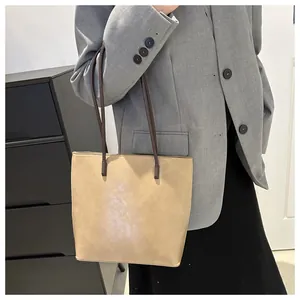 Minimalist beige tote bag shown with professional grey blazer for daily commute