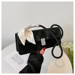 Détail du sac bandoulière en velours noir avec boucle strass et poignée foulard