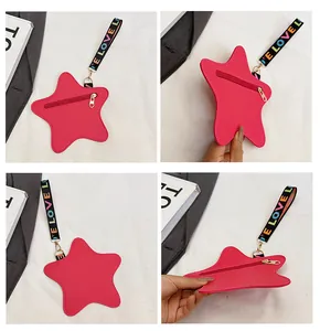 Detail of star-shaped crossbody purse in rose pink with textured leather and wrist strap