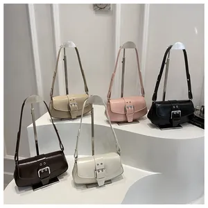 Detailed view of vintage glossy leather shoulder bags with large square buckle in five colors