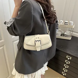 Chic beige baguette bag with silver buckle and adjustable strap for casual daily commuting