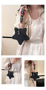 Detail of star-shaped black pebbled leather crossbody bag with colorful LOVE wrist strap