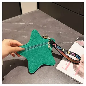 Detail of green star-shaped coin purse with heart zipper and LOVE print wrist strap