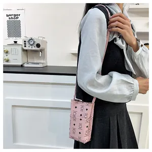 Mini sac seau rose avec imprimé ours et bandoulière fine porté par un mannequin
