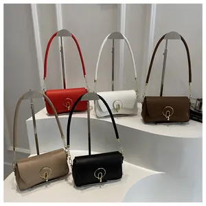 Detail view of five trendy rectangular flap crossbody bags with circular metal buckles