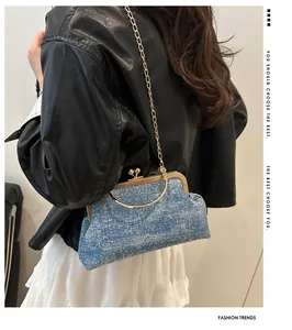 Close-up of blue denim shell bag with gold circular handle and metal chain strap