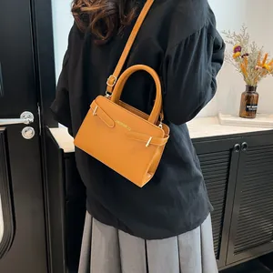 Caramel leather crossbody bag with top handle and adjustable strap for elegant women