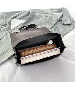 Internal view of the large capacity dark brown leather messenger bag with various items