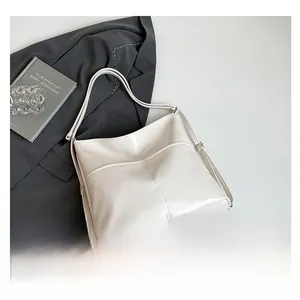 Detailed top view of a large cream white tote bag with front pocket and dual straps