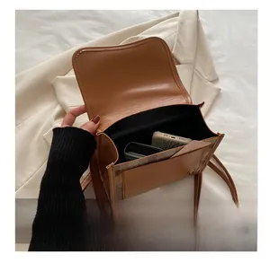 Detail view of the brown leather backpack interior showing capacity for phone and card holder