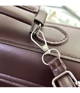 Detailed macro view of high-quality silver metal hooks and leather straps on the bag