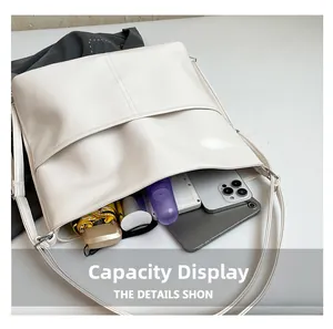 Large white faux leather tote bag showing spacious interior with tablet and accessories