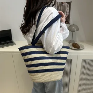 Classic navy blue striped woven tote bag with bamboo handles for summer beach outings