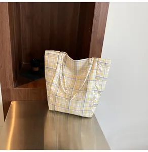 Detailed view of yellow and grey plaid canvas tote bag with spacious open-top design
