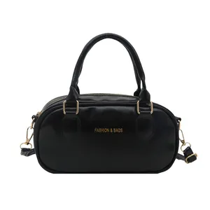 Retro black glossy leather mini Boston bag with golden hardware and top handles