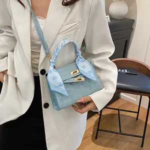 Light blue crocodile pattern handbag with gold clasp and heart motif silk scarf
