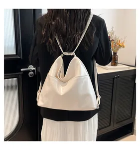 Detail of off-white leather hobo bag showing metallic ring buckle and side pocket