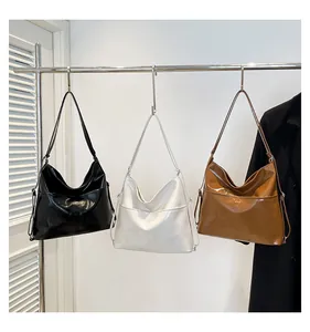 Detail of adjustable slender straps and metal buckles on stylish large capacity tote bags