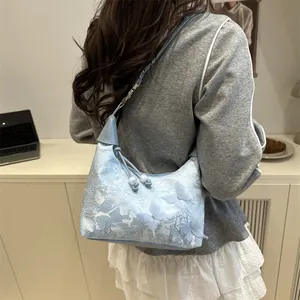 Light blue Chinese style underarm bag with lace embroidery and butterfly details