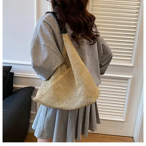Model showing a large beige woven straw tote bag with casual Bohemian summer style