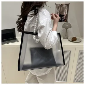 Detail of transparent tote bag with thick rope handles and black inner pouch