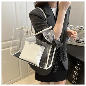Detail of transparent PVC tote bag with white cotton rope handle and inner leather pouch