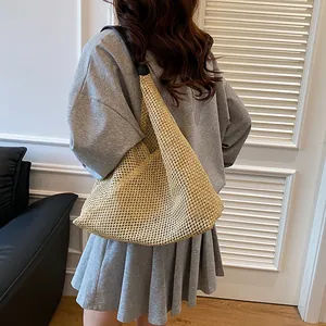 Woven hobo shoulder bag for women featuring beige crochet texture and black leather strap