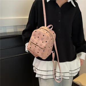 Pink mini backpack with cute bear print and gold zippers shown from a side view angle