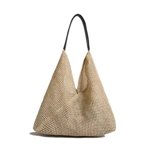 Minimalist woven straw tote bag for women with black faux leather shoulder straps