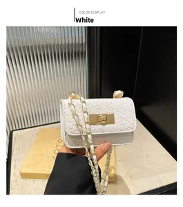 Detail of white quilted woven leather mini bag with gold chain strap and metal clasp