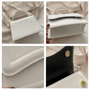 Détails d'un sac rectangulaire blanc montrant les coutures et le fermoir aimanté doré
