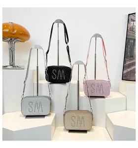 Detail of glitter mini crossbody bags with SM metal rivets in four colors for parties