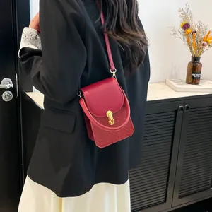 Vintage red leather handbag with gold lock shown in a stylish lifestyle back view setting