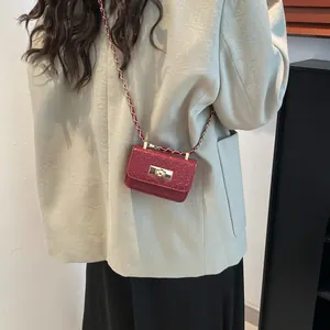 Chic burgundy mini crossbody bag with gold twist lock and metal chain strap for women