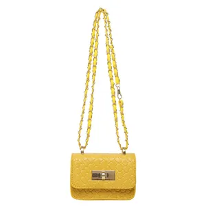 Yellow woven mini crossbody bag with gold chain strap and turn-lock closure