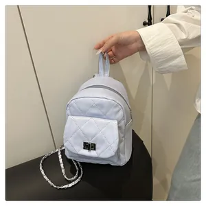 Detail of lavender quilted mini backpack with silver twist lock and chain strap