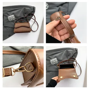 Detail view of brown crossbody bag with gold hardware and smooth leather texture