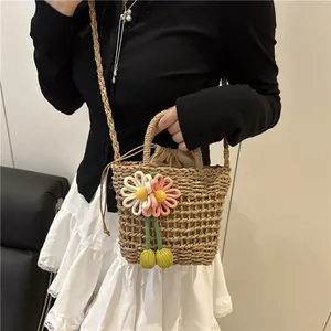 Handwoven straw bucket bag with 3D floral accents and drawstring liner for summer beach