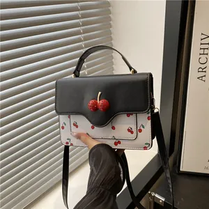 Cute cherry print crossbody bag with 3D cherry charm and contrasting white and black panels