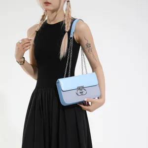 Light blue crossbody bag with textured fabric and elegant silver chain strap