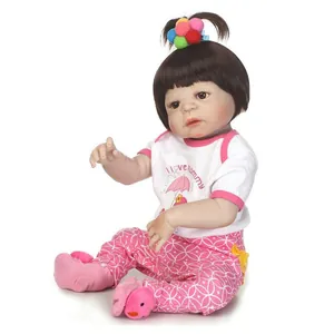 Lifelike reborn baby doll with brown hair in white I love Mommy t-shirt and pink pants