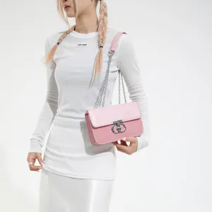 Minimalist light pink leather crossbody bag with silver chain strap and metal lock buckle