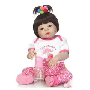 Realistic reborn baby doll girl with black hair, pink outfit, bottle and pacifier