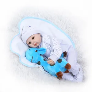 Lifelike reborn baby doll in blue striped outfit with a matching plush giraffe toy