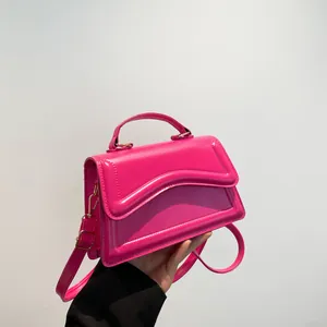 Hot pink glossy PU leather crossbody bag with curved flap and gold hardware accents